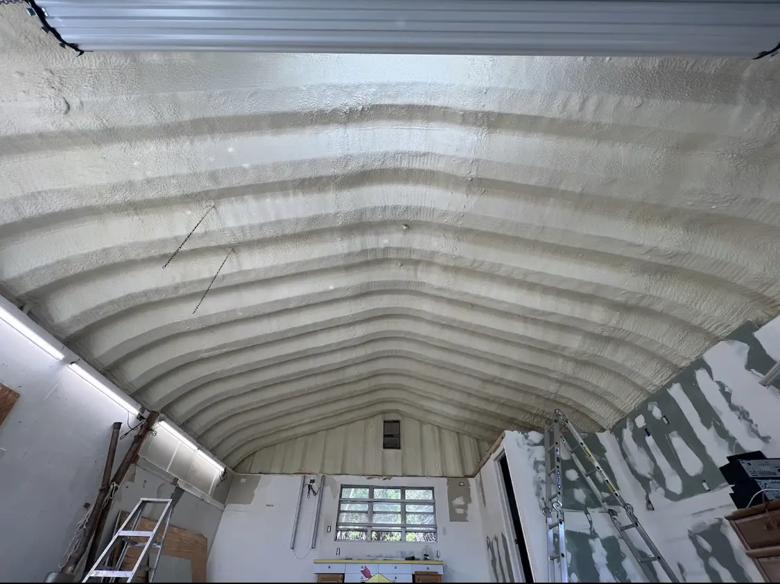 Spray polyurethane foam applied to the underside of a metal roof deck in Addis